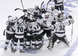 Charles Rex Arbogast/ Associated Press The Kings celebrate after clinching the Western Conference Sunday night.