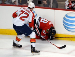 David Banks/USA Today Sports Patrick Kane curls up in pain after initially breaking his collarbone in action late February.